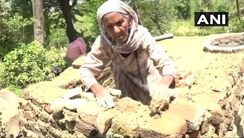 The elderly woman constructed the toilet with her own hands as she cannot afford masons. building toilet