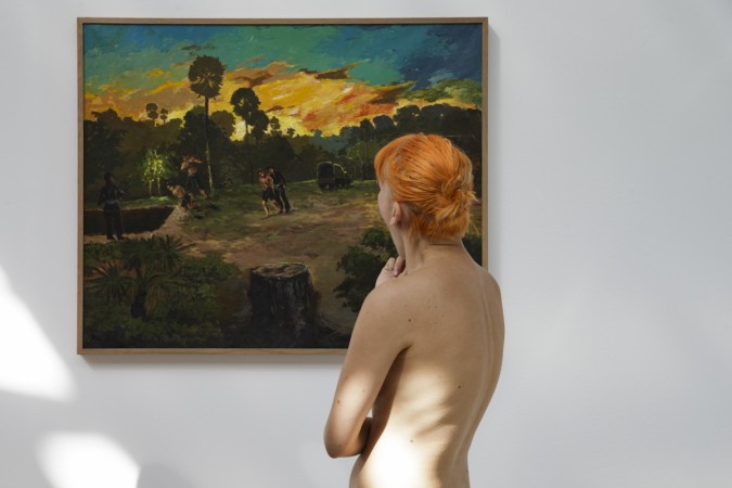 People take part in a nudist visit of the 'Discorde, Fille de la Nuit' season exhibition at the Palais de Tokyo museum in Paris on May 5, 2018 Palais de Tokyo museum in Paris