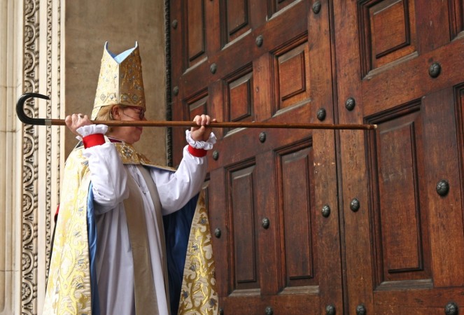 Sarah Mullally bangs on the door with her crosier during a ceremony to install her as the 133rd Bishop of London at St Paul's Cathedral in London on May 12, 2018. Sarah Mullally