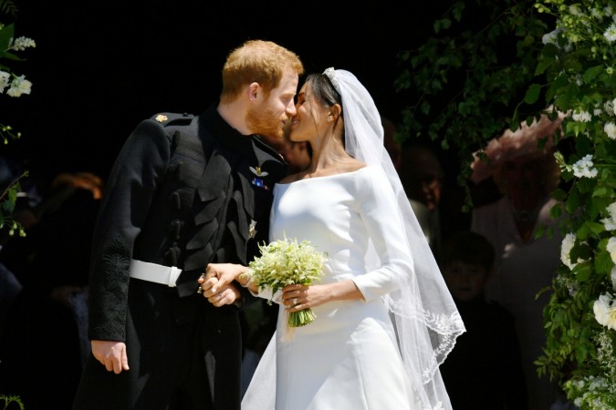 Prince Harry and Meghan Markle kiss on the steps of St George's Chapel in Windsor Castle after their wedding in St George's Chapel at Windsor Castle on May 19, 2018 in Windsor, England. Prince Harry Meghan Markle kiss