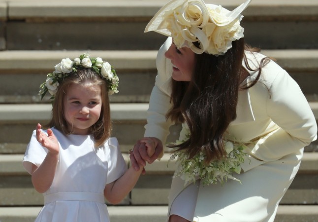Princess Charlotte (L) waves by her mother Britain's Catherine, Duchess of Cambridge after attending the wedding ceremony of Britain's Prince Harry, Duke of Sussex and US actress Meghan Markle at St George's Chapel, Windsor Castle, in Windsor, on May 19, 2018 Princess Charlotte, Duchess of Cambridge