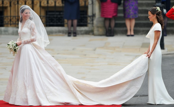 Catherine Middleton waves to the crowds as her sister and Maid of Honour Pippa Middleton holds her dress before walking in to the Abbey to attend the Royal Wedding of Prince William to Catherine Middleton at Westminster Abbey on April 29, 2011 in London, England. Kate Middleton, Pippa Middleton