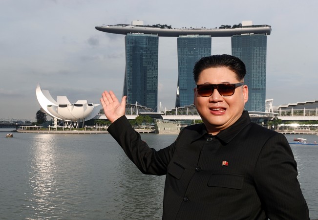 Howard, an Australian-Chinese impersonating North Korean leader Kim Jong Un, poses with the Marina Bay Sands hotel in the background in Singapore Howard X, Kim Jong-un's doppelganger
