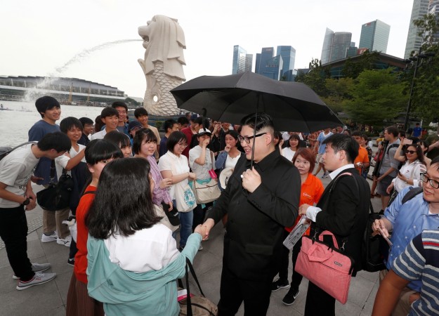 Howard, an Australian-Chinese impersonating North Korean leader Kim Jong Un, talks to South Korean students at the Merlion Park in Singapore Howard X, Kim Jong-un's doppelganger