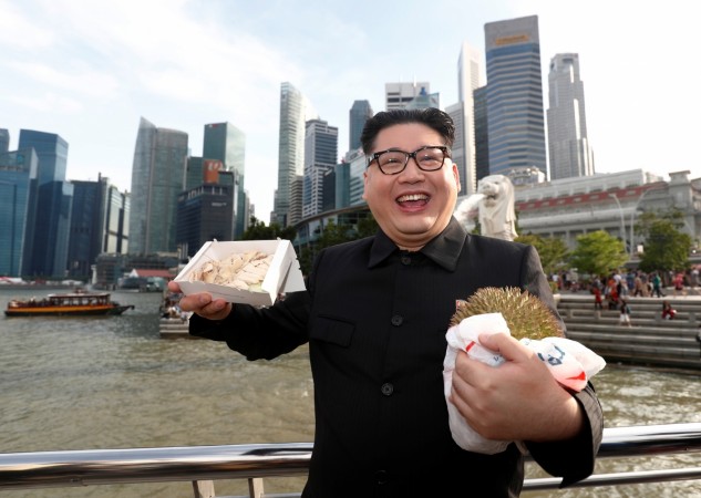Howard, an Australian-Chinese impersonating North Korean leader Kim Jong Un, poses with a durian and a box of chicken rice Howard X, Kim Jong-un's doppelganger