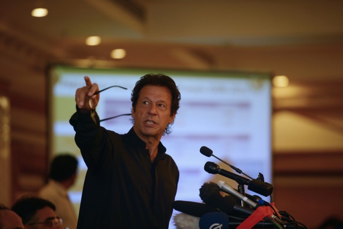 Former Pakistani cricketer and politician Imran Khan gestures during a press conference in Islamabad on August 5, 2014. Imran Khan