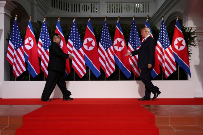 U.S. President Donald Trump and North Korean leader Kim Jong Un prepare to shake hands at the Capella Hotel on Sentosa island in Singapore June 12, 2018. Donald Trump Kim Jong Un