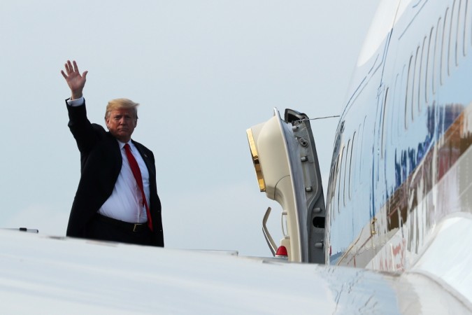 U.S. President Donald Trump waves as he boards Air Force One after his summit with North Korean leader Kim Jong Un in Singapore June 12, 2018. Donald Trump leaves Singapore