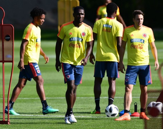 Midfielder Juan Cuadrado, defender Cristian Zapata and defender Santiago Arias stand on the pitch during a training session Colombia Fifa World Cup team