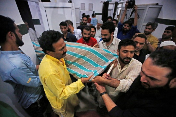 People carry the body of Syed Shujaat Bukhari, the editor of Rising Kashmir daily newspaper, who was killed by unidentified gunmen outside his office in Srinagar, June 14, 2018. Shujaat Bukhari