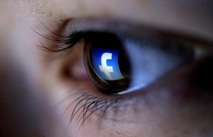 A Facebook logo reflects on a woman's eye. Facebook Blinking Selfie Tool