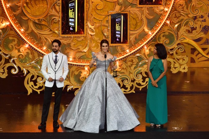 Bollywood actress Kriti Sanon (C) receives the Most Stylish Icon award from Bollywood actor Ayushmann Khurrana (L) and Deepika K, director of brand marketing Myntra.com looks on during the IIFA Awards of the 19th International Indian Film Academy (IIFA) festival at the Siam Niramit Theatre in Bangkok on June 24, 2018 Kriti Sanon