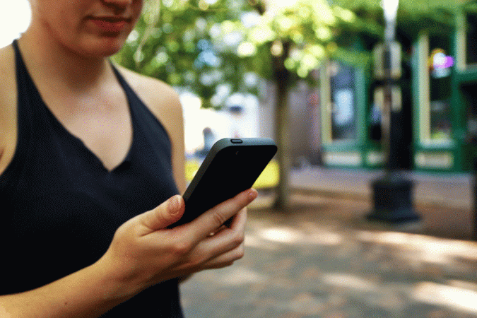 A woman watching his phone for representation purpose only Tubidy music app