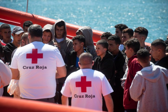 Red Cross members assist young migrants on board the 'Guardamar Luz de Mar' Spanish rescue ship upon their arrival at Algeciras' harbour on June 27, 2018 after being rescued at sea SPAIN-EU-MIGRANTS-RESCUE-MINORS
