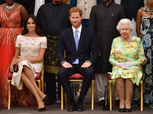 Meghan, Duchess of Sussex, Britain's Prince Harry, Duke of Sussex and Britain's Queen Elizabeth II pose for a picture during the Queen's Young Leaders Awards Ceremony on June 26, 2018 at Buckingham Palace in London. Meghan Markle