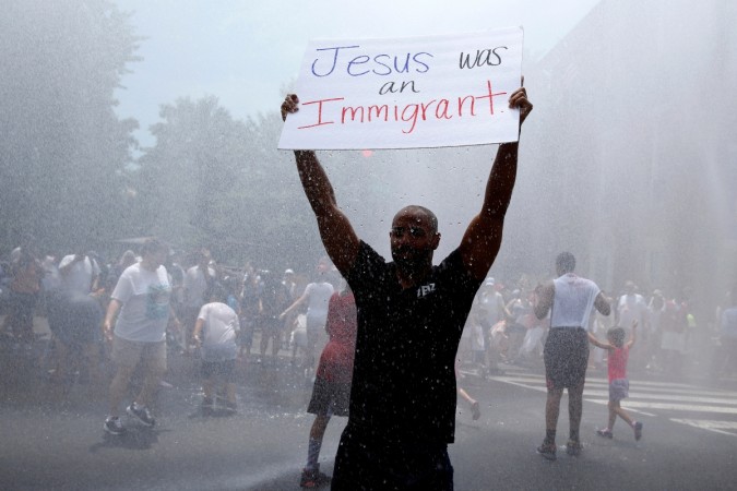 A demonstrator holds up a placard during a national day of action called Deonstrator hold up a placard at the anti-Trump protest in Los Angeles