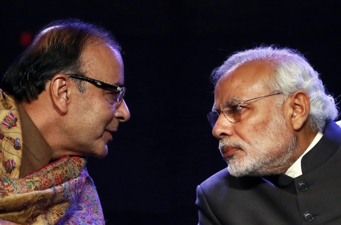Indian Prime Minister Narendra Modi (R) listens to Finance Minister Arun Jaitley during the Global Business Summit in New Delhi January 16, 2015. Modi said on Friday that he was committed to meeting this year's budget deficit target, and he welcomed a cut in interest rates by the Reserve Bank of India on the back of falling inflation. Arun Jaitley with Narendra Modi