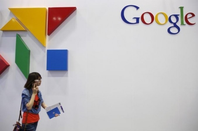 A woman walks past a logo of Google at the Global Mobile Internet Conference (GMIC) 2015 in Beijing, China, April 28, 2015. Google marks millions of websites unsafe