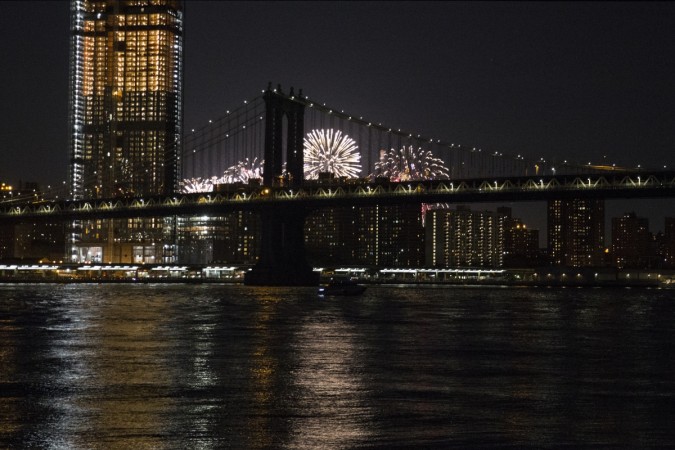 Fireworks are seen from the East River on the South Brooklyn route of a New York City ferry on July 4, 2017 US Independence Day 2017