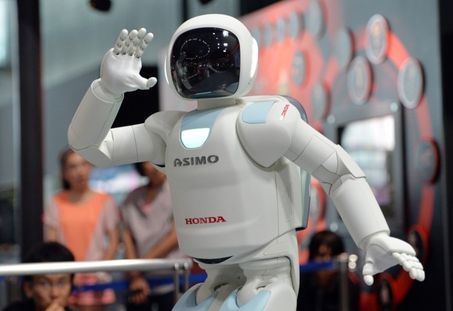 Honda Motor's humanoid robot Asimo interacts with visitors at the National Museum of Emerging Science and Innovation in Tokyo on July 3, 2013 Honda Asimo