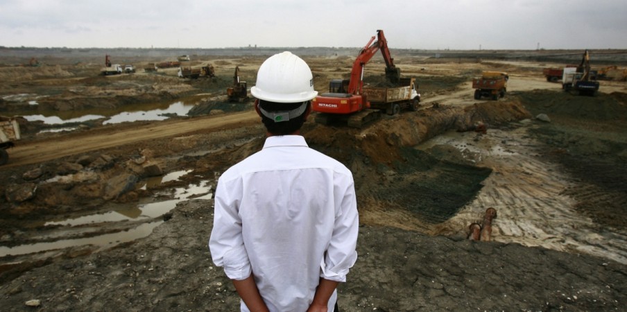 A Chinese engineer looks over the excavation process at the construction site for the new deep water shipping port in Hambantota, 240km (149 miles) southeast of Colombo, March 24, 2010. The port is a joint venture between Sri Lanka and China, and when completed will be the largest port in the country and expects to attract more then 100 vessels a day. China was the largest foreign funding source for Sri Lanka in 2009 with $1.2 billion. Picture taken March 24 2010. Chinese engineer at Hambantota port in Sri lanka