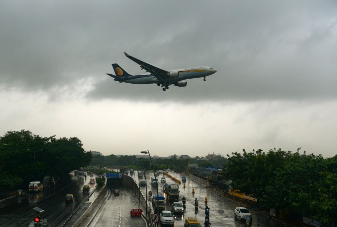 An aircraft of India's Jet Airways lands in Mumbai on September 20, 2017, in rain. India's first private airline's future looks cloudy as potential investors have shown reluctance to come up with viable bids. An aircraft of India's Jet Airways lands