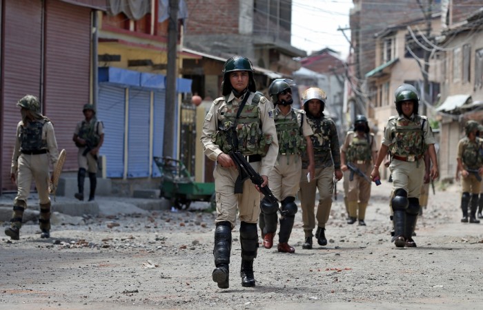 Members of the security forces patrol a street littered with rocks thrown by protestors in Srinagar as the city remains under curfew following weeks of violence in Jammu and Kashmir, August 19, 2016. Indian security forces during curfew in Srinagar