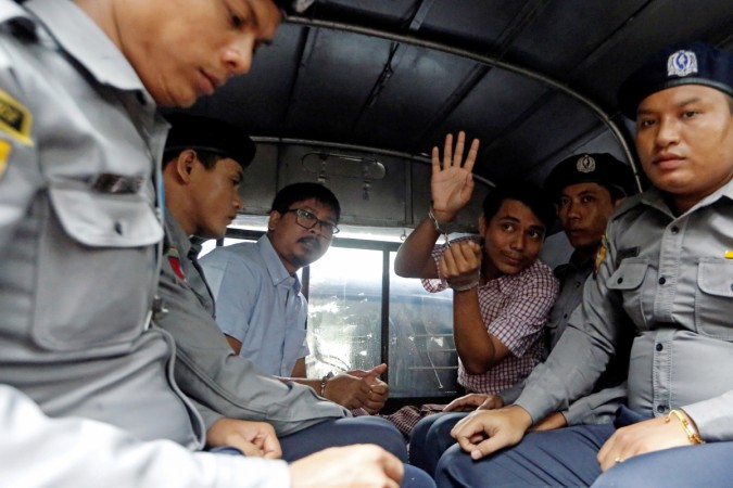 Detained Reuters journalist Wa Lone and Kyaw Soe Oo sit beside police officers as they leave Insein court in Yangon, Myanmar Reuters journalist Wa Lone and Kyaw Soe Oo