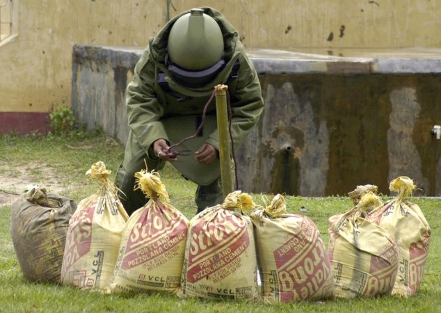 A bomb squad member tries to defuse a bomb