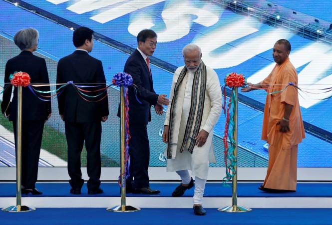 Indian Prime Minister Narendra Modi walks, as South Korean President Moon Jae-in and Yogi Adityanath, Chief Minister of Uttar Pradesh state look on after inaugurating the Samsung Electronics smartphone manufacturing facility in Noida, Samsung's smartphone manufacturing facility inauguration.
