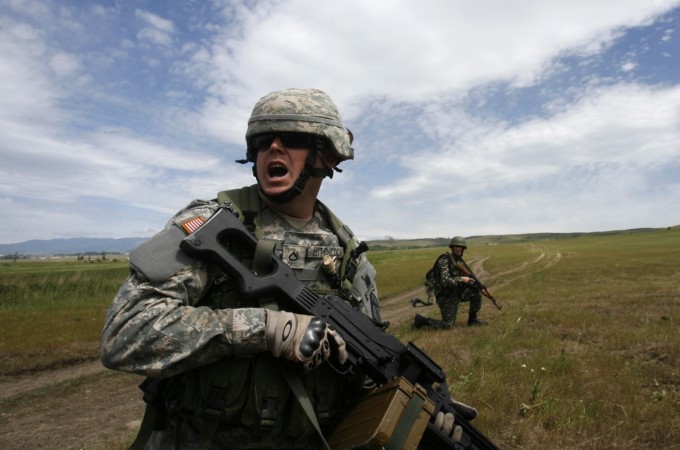A U.S. military instructor (L) leads during a NATO exercise named American soldier