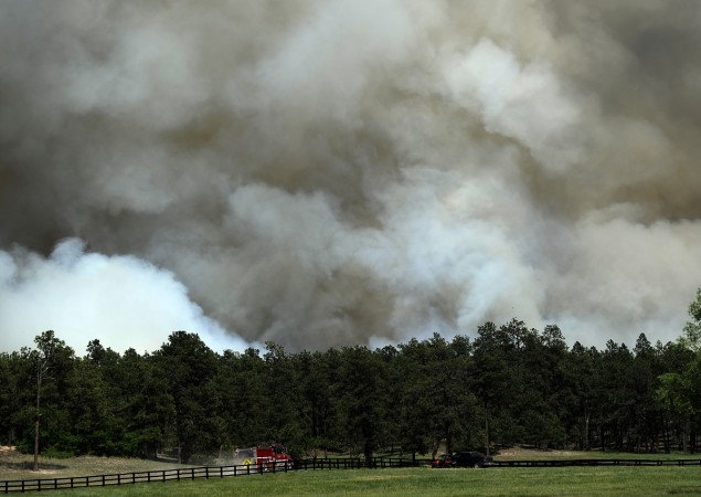 : A fire truck approaches a wall of smoke from the Black Forest Fire north of Colorado Springs Wildfire Threatens Homes In Colorado Springs Area