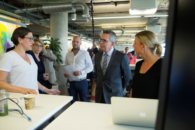 German Interior Minister Thomas de Maiziere talks to employees during a vistit at the Facebook office in Berlin German Interior Minister Thomas de Maiziere talks to employees during a vistit at the Facebook office in Berlin