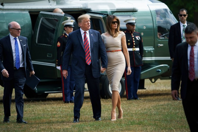 US President Donald Trump (C) and US First Lady Melania Trump (R) walk with US Ambassador to the United Kingdom Woody Johnson (L) as they arrive at the US ambassador's residence Winfield House in London on July 12, 2018. Melania Trump dresses