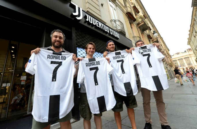 Juventus supporters holding new jersey printed with the name and number of Cristiano Ronaldo Cristiano Ronaldo Juventus