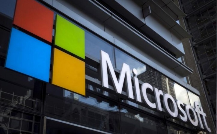 A Microsoft logo is seen on an office building in New York City in this July 28, 2015 file photo. Microsoft Corp announced more big cuts to its smartphone business on Wednesday. Microsoft