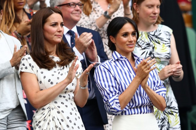 Catherine, Duchess of Cambridge and Meghan, Duchess of Sussex applaud ahead of the Ladies' Singles final match between Serena Williams of The United States and Angelique Kerber of Germany on day twelve of the Wimbledon Lawn Tennis Championships at All England Lawn Tennis and Croquet Club on July 14, 2018 in London, England. Kate Middleton, Meghan Markle
