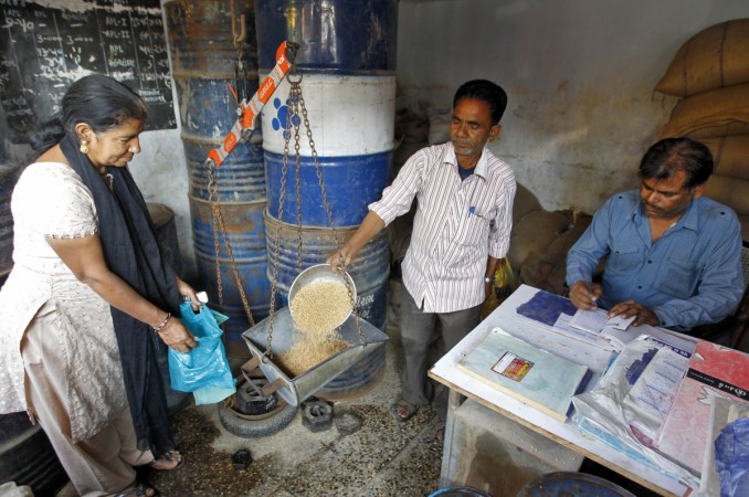 A woman who holds a BPL (Below Poverty Line) card buys wheat from a government-run ration shop in the western Indian city of Ahmedabad A woman buys wheat from a government-run ration shop