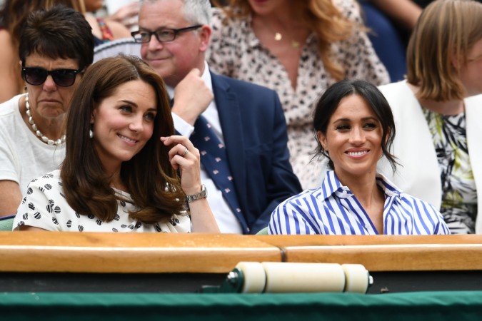 Catherine, Duchess of Cambridge and Meghan, Duchess of Sussex attend day twelve of the Wimbledon Lawn Tennis Championships at All England Lawn Tennis and Croquet Club on July 14, 2018 in London, England. Meghan Markle Kate Middleton