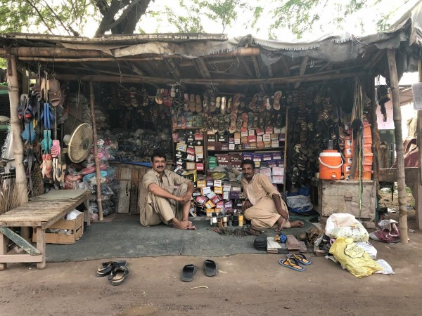 Ahmadi men sit at a cobbler shop at a market in the town of Rabwah, Pakistan. rabwah