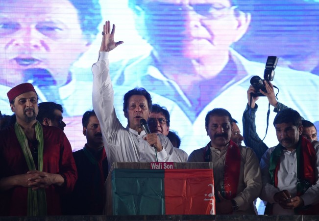 Pakistani cricket star-turned-politician and head of the Pakistan Tehreek-e-Insaf (PTI) Imran Khan (C) gestures as he delivers a speech during a campaign meeting ahead of the general election in Lahore on July 23, 2018. pakistan general elections
