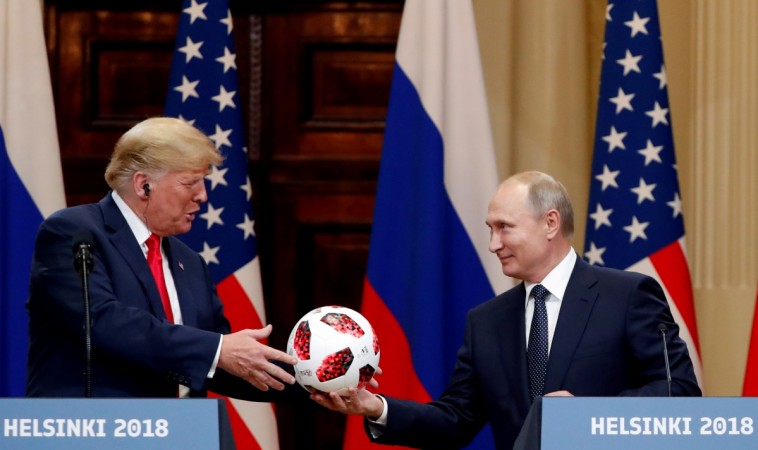 U.S. President Donald Trump receives a football from Russian President Vladimir Putin as they hold a joint news conference after their meeting in Helsinki, Finland July 16, 2018 Trump Putin Helsinki summit