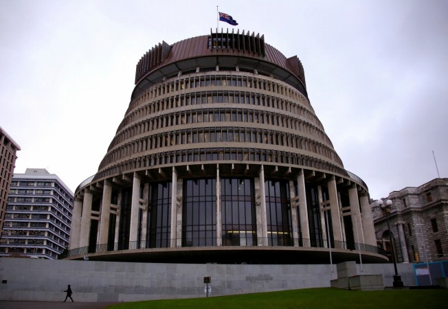 A pedestrian walks past the New Zealand parliament building known as the Beehive in central Wellington, New Zealand, July 3, 2017. New Zealand parliament building