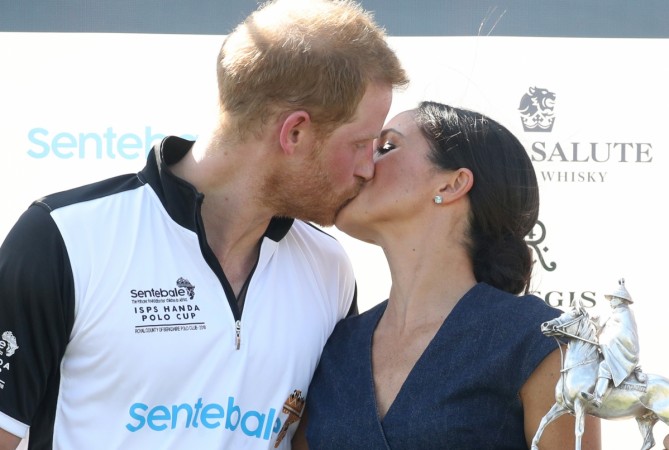 Meghan Duchess of Sussex and Prince Harry Duke of Sussex kiss after posing with the trophy after the Sentebale Polo 2018 held at the Royal County of Berkshire Polo Club on July 26, 2018 in Windsor, England. Meghan Markle Prince Harry kissing
