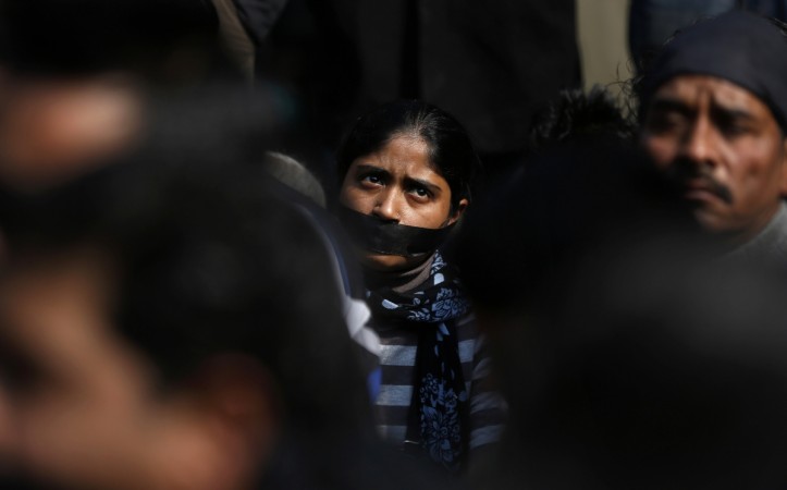 A protester with a gag tied around her mouth takes part in a silent protest for a gang rape victim in New Delhi December 29, 2012. The Indian woman whose gang rape in New Delhi triggered violent protests died of her injuries on Saturday in a Singapore hospital, bringing a security lockdown in Delhi and recognition from India's prime minister that social change is needed. Rape in India