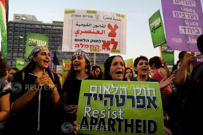 Israeli Arabs and their supporters take part in a rally to protest against Jewish nation-state law in Rabin square in Tel Aviv, Israel israel jews arabs.