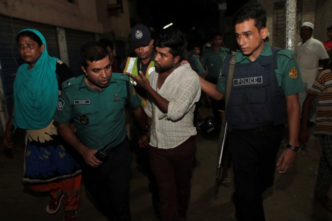 Police detain a man, brother of an alleged drug dealer Farhad Hossain Babu, during an anti drug raid in Dhaka, Bangladesh, June 4, 2018. Picture taken June 4, 2018. Bangladesh drug war