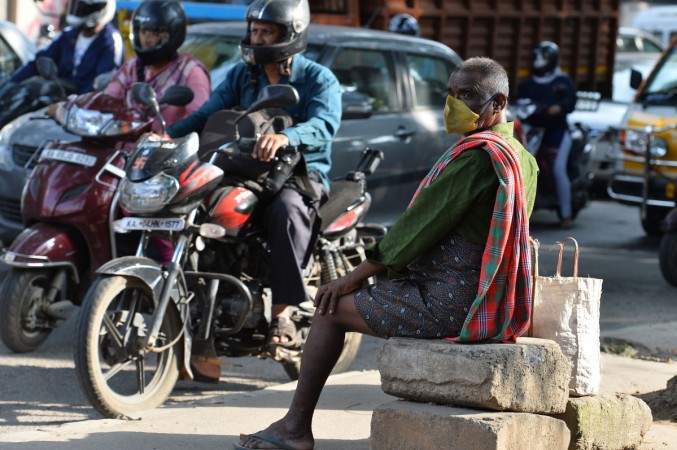 An elderly Indian man wears a respiratory mask to cover his face from dust and pollution. Air pollution in Bangalore2
