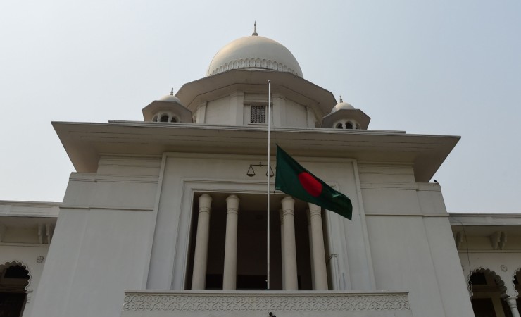 The Bangladeshi national flag is seen flown at half mast outside the High Court Building in Dhaka on March 15, 2018, as a gesture of mourning for victims of the US-Bangla Airlines plane crash in Kathmandu. Bangladesh high court