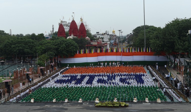Indian schoolchildren sit in formation forming Hindi script that reads 'Bharat', or India, during a full dress rehearsal for India's 72nd Independence Day celebrations at the Red Fort in New Delhi on August 13, 2018. - India celebrates the anniversary of its independence from Britain on August 15. independence day